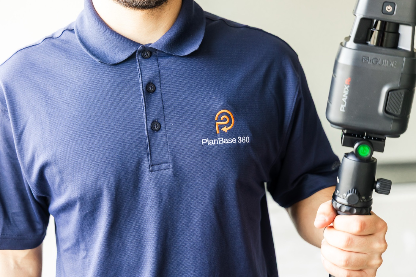 PlanBase 360 operator on site beside a LiDAR scanner during a commercial survey