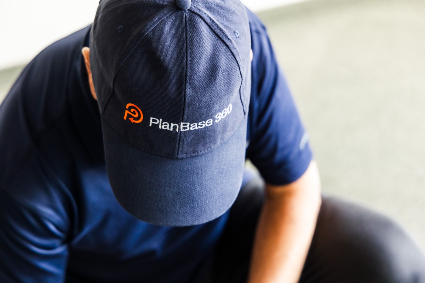 PlanBase 360 operator in a branded cap working with the scanning equipment