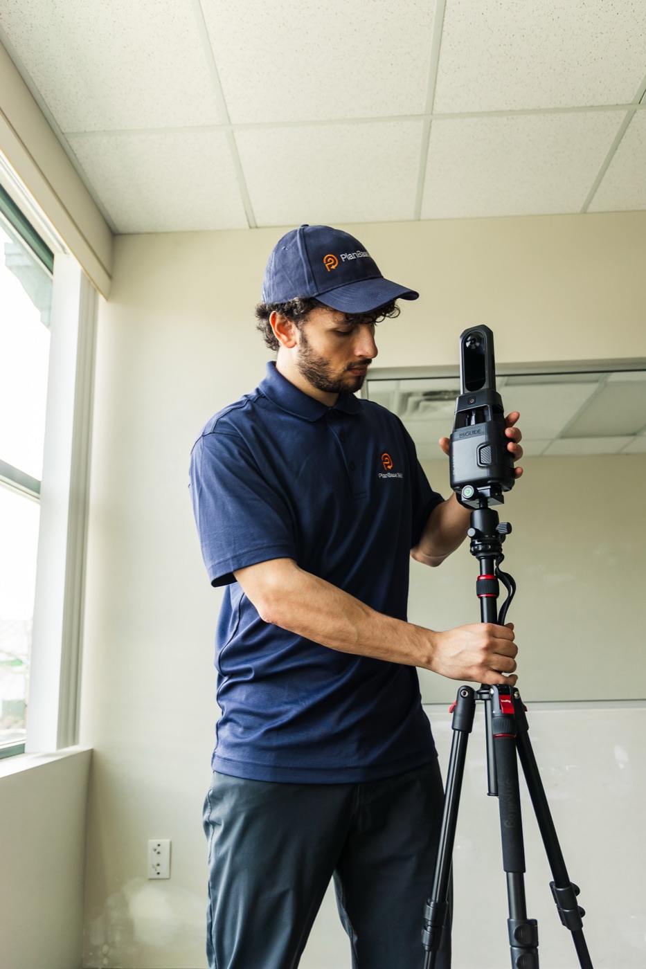 PlanBase 360 operator scanning a commercial office with an iGUIDE PLANIX LiDAR system
